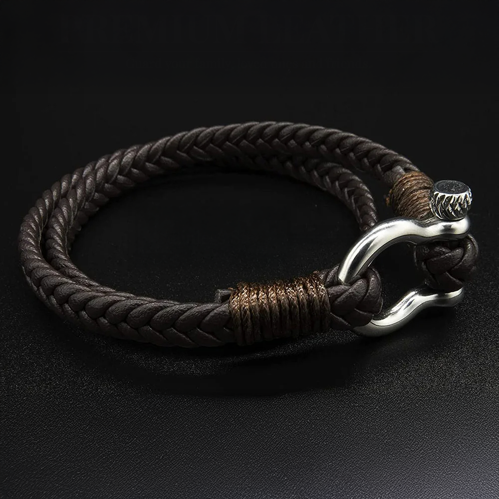 Bracelet with braided leather strap and silver clasp on a dark background