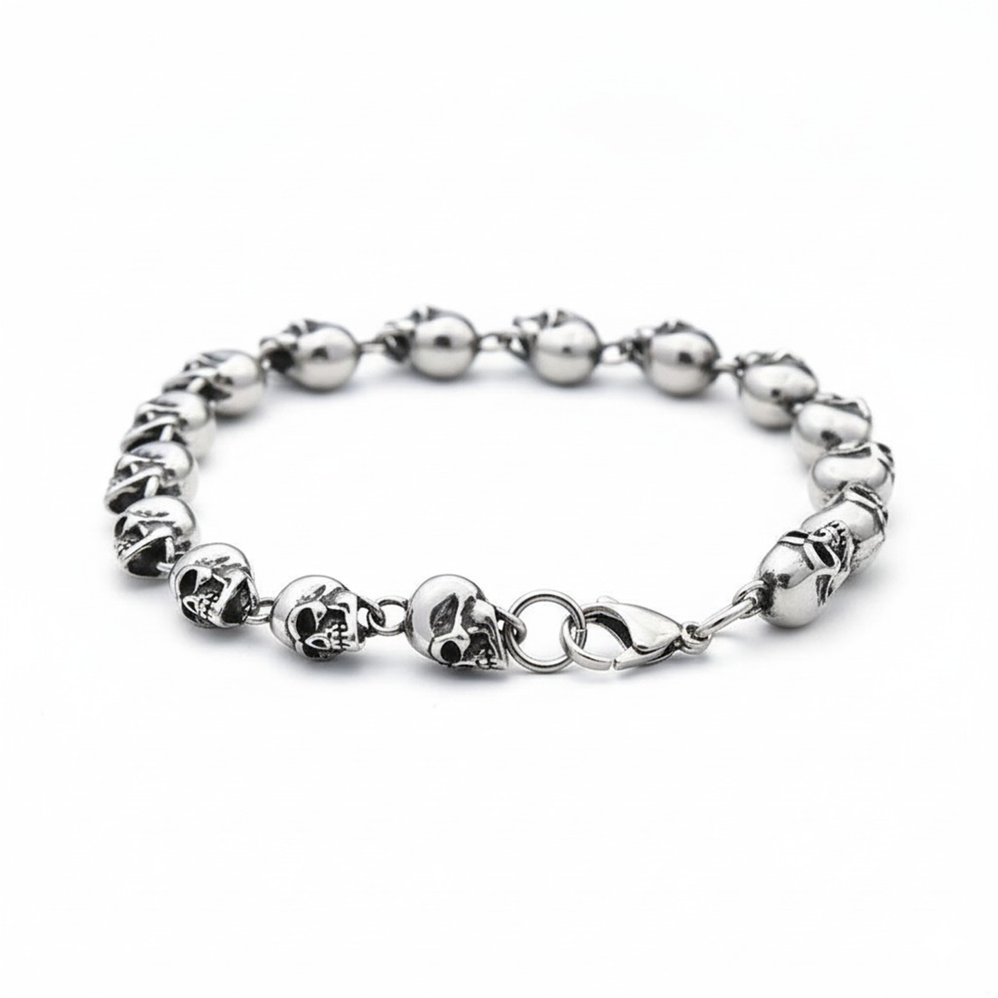 Silver bracelet with skull designs on a white background
