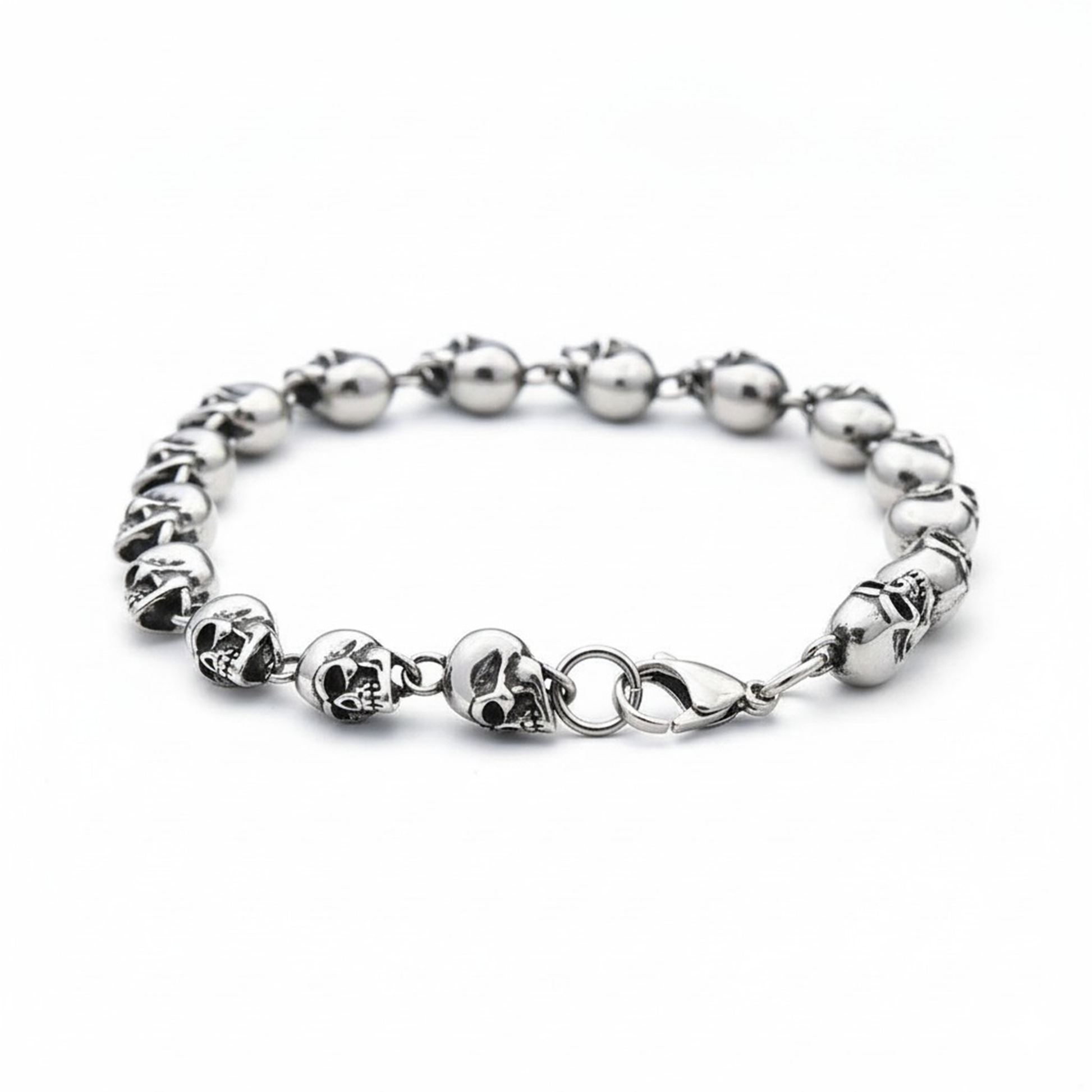 Silver bracelet with skull designs on a white background