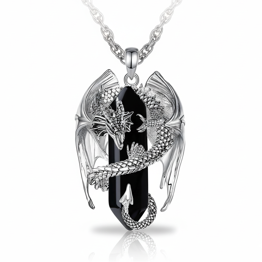 Silver pendant with black stone and dragon design on a white background