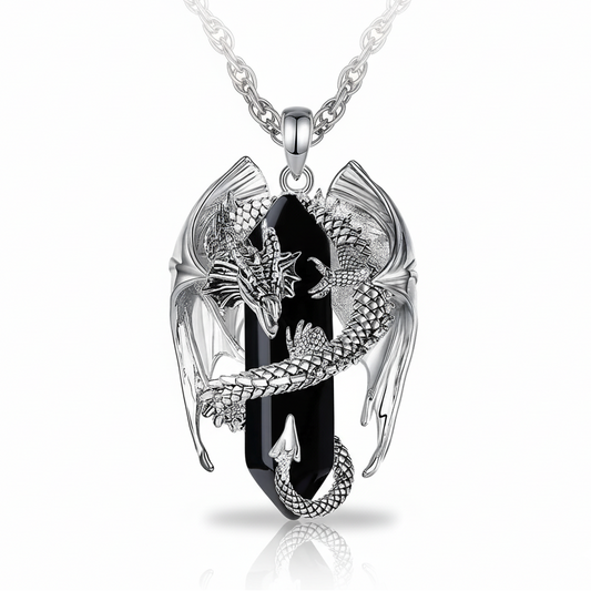 Silver pendant with black stone and dragon design on a white background
